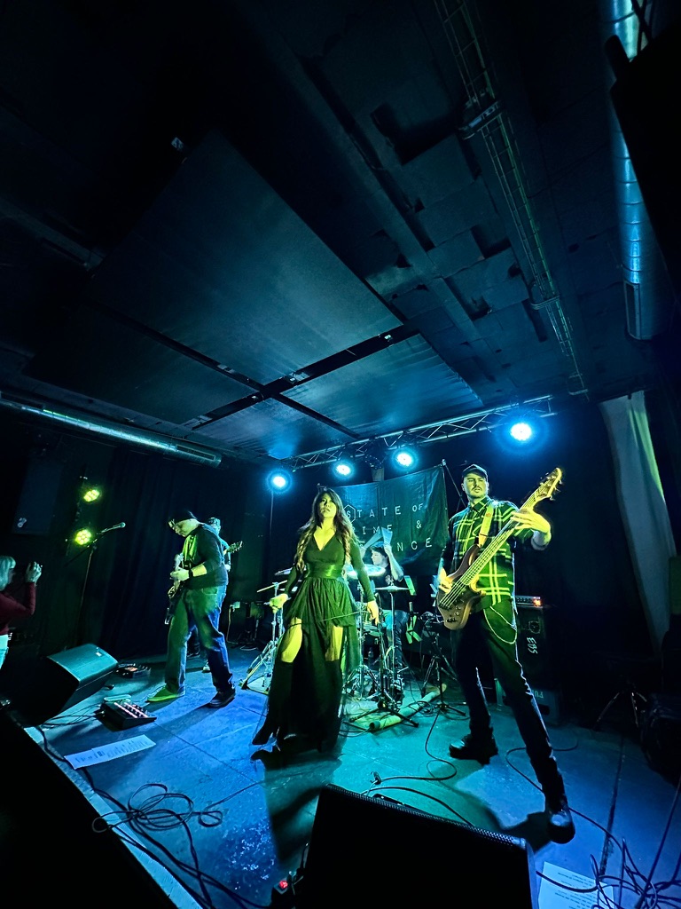 State of Crime and Science performing under blue stage lights